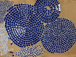 Mathilde Jonquière, mosaic artist, June 2023, original creation of a “Bleu d’ailleurs” table for Petit H, dimensions 1.70m x 070m. Mathilde Jonquière hand-cuts each Hermès plate according to its own design.